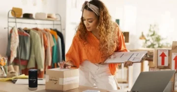 Restaurant owner behind the counter working on a tablet