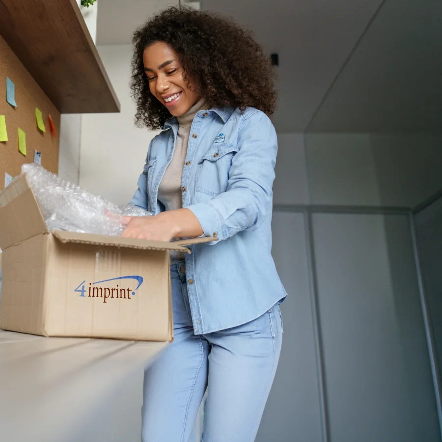 Smiling person opening a 4imprint package