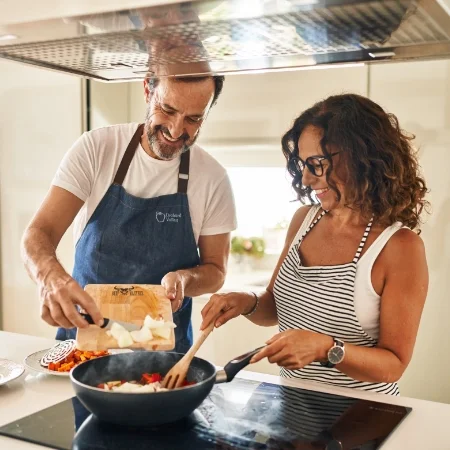 Smiling couple cooking together.