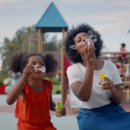 Mother and daughter blowing bubbles.