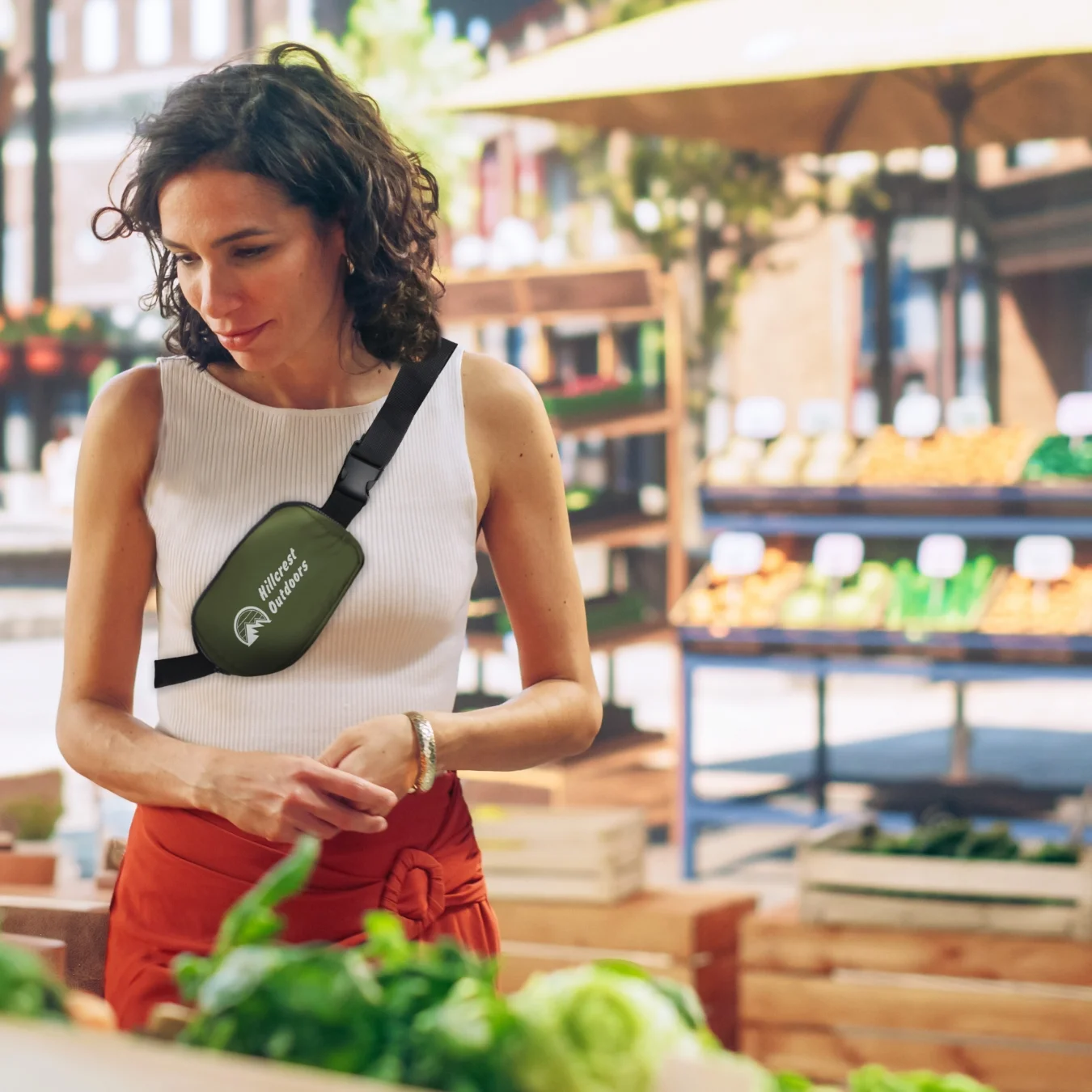 Person shopping at the farmers market with a crossbody bag across their chest.