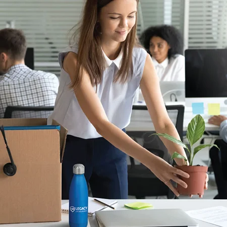 A new hire with a water bottle at her desk