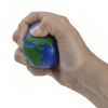 a hand holding a small blue and green ball