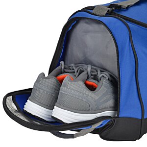 Additional Image 1 - a blue duffel bag with grey shoes inside