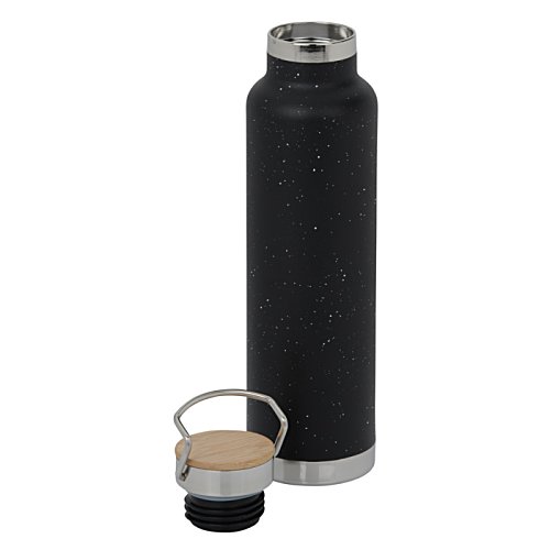 Additional Image 1 - a black bottle and a small glass of liquid