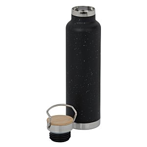 Additional Image 1 - a black bottle and a small glass of liquid