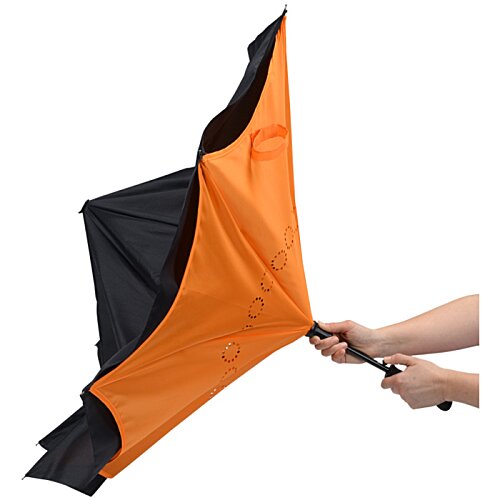 Additional Image 3 - a person holding an orange and black umbrella