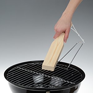 Additional Image 2 - a hand holding a wood block over a black grill