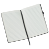 a white notebook with a black pen