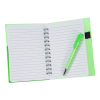 a green pen on a notebook