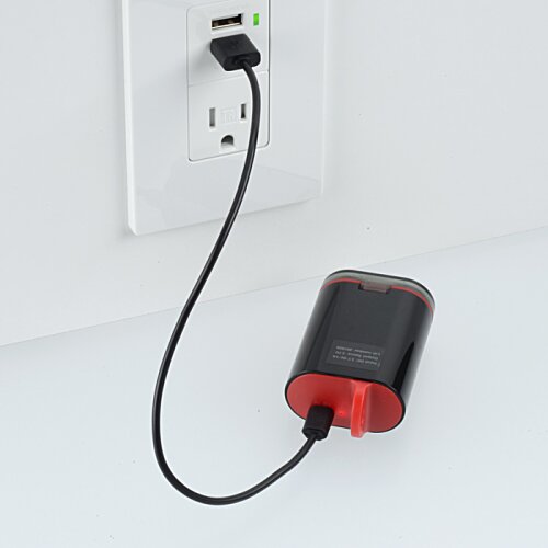 Additional Image 3 - a black and red device with a cord plugged into a wall outlet