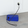 a blue rectangle with a black cord plugged into a wall