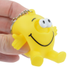 a hand holding a yellow toy