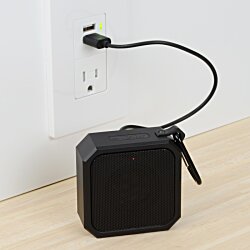 a black square object with a cord plugged into a wall