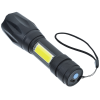 a black flashlight with a yellow label