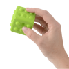 a hand holding a green block