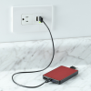 a red device plugged into a wall outlet