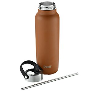 Additional Image 3 - a brown bottle with a silver lid and headphones