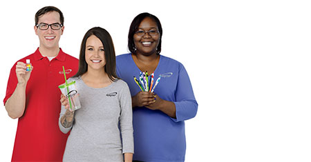 Group of 4imprint employees holding promotional products