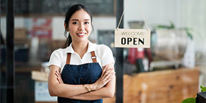 Employee standing near open sign.