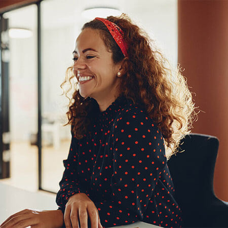 Happy person sitting at their desk at work.