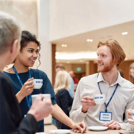 group of event attendees talking over coffee