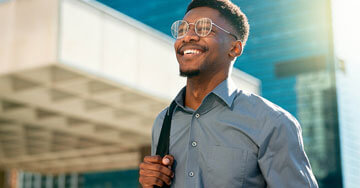 Happy businessman walking outside.