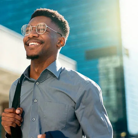 Happy businessman walking outside.