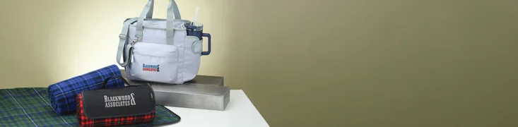 Business Gifts that include a tumbler with straw, blanket and cooler bag