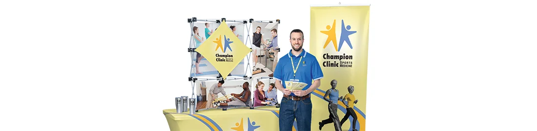 Promotional tradeshow items that include a vertical banner, display and table throw 