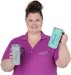 Wendy holding two of the Acadia Camp Travel Mugs