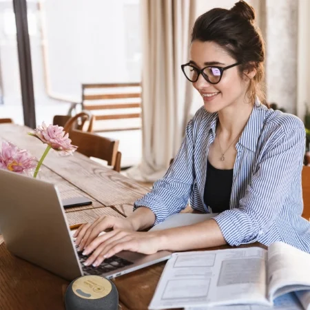 Happy person working on a laptop at home.