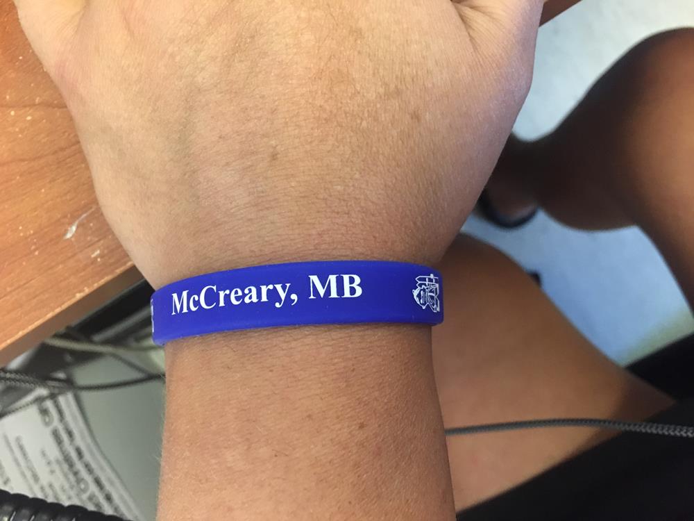 a wrist with a blue band on it