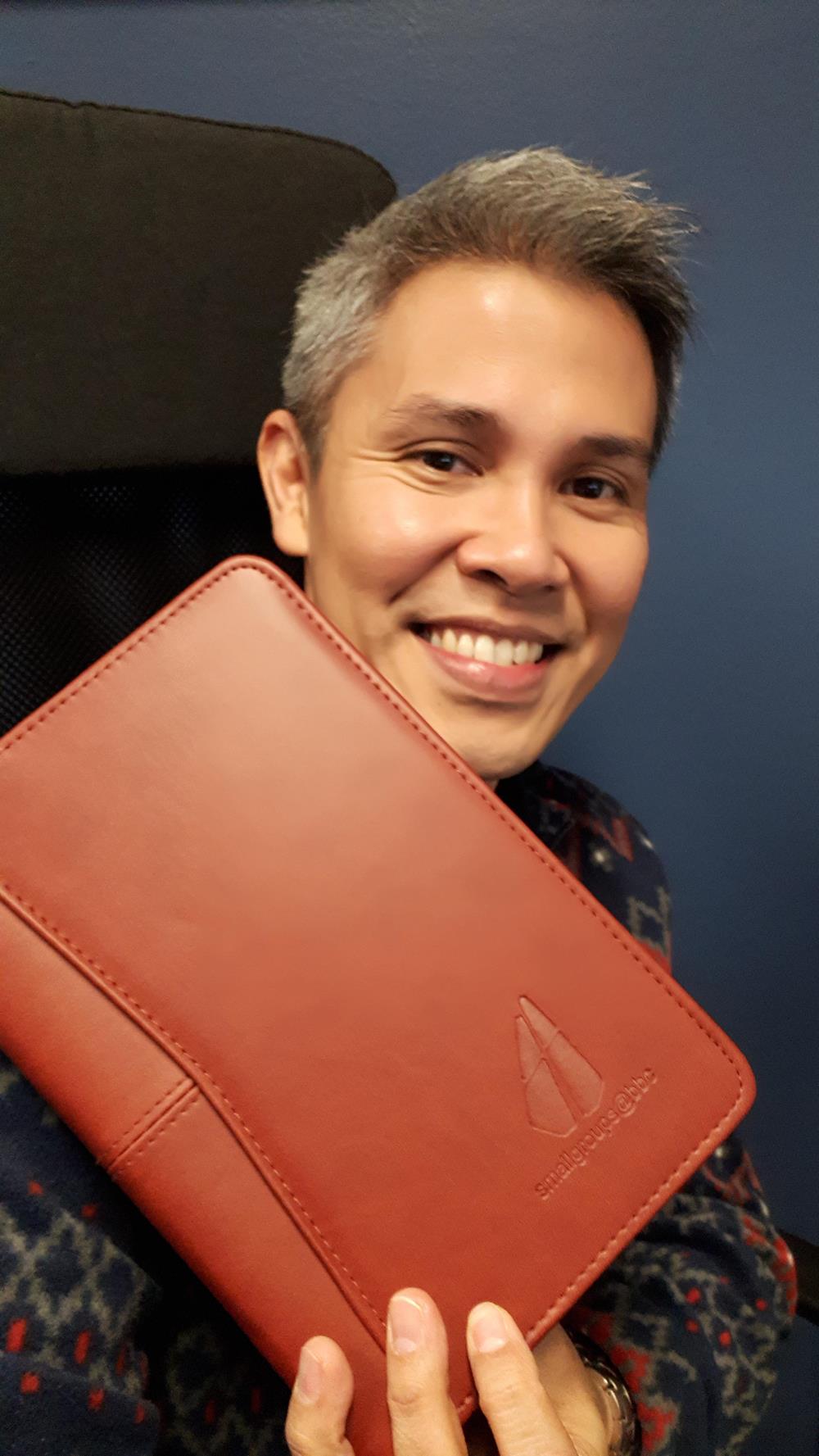 a man holding a leather wallet