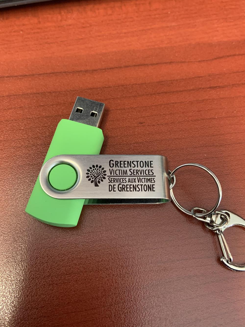 a green and silver usb flash drive