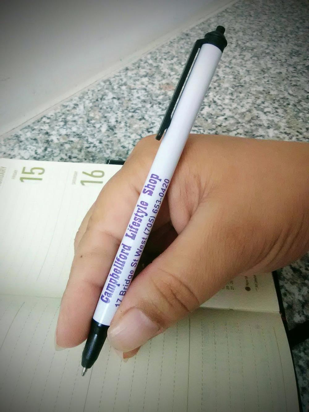 a hand holding a pen