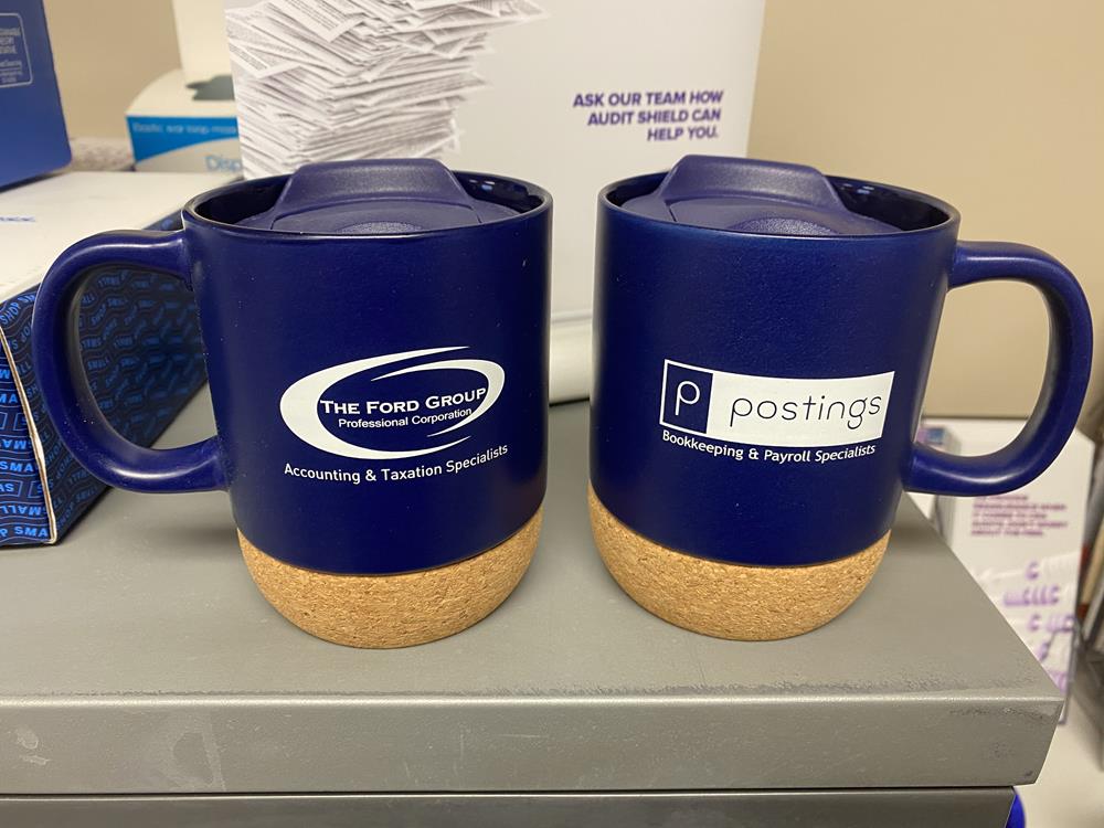 two blue mugs with cork rims