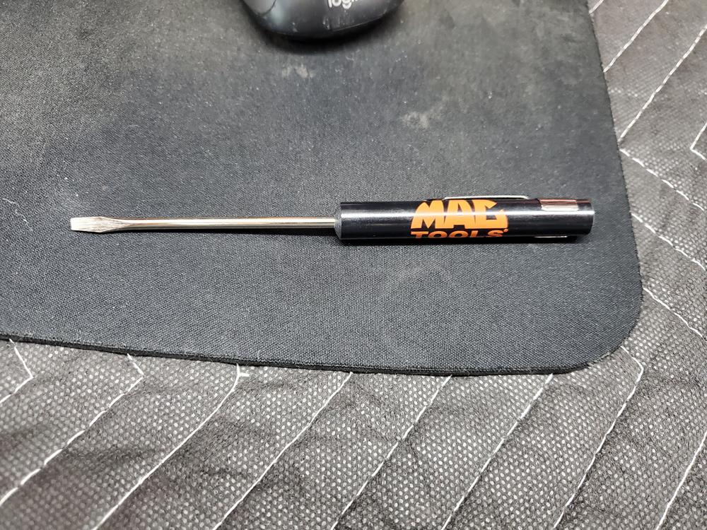 a screwdriver on a mouse pad