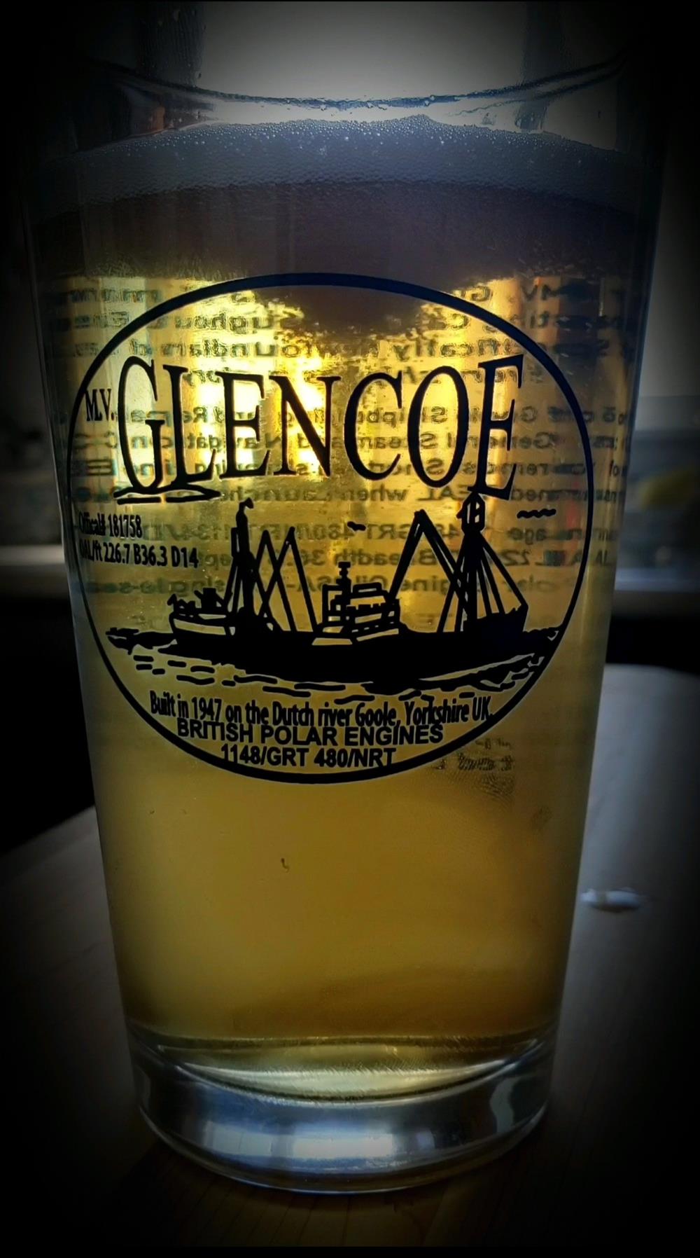 a glass of beer with a logo on it
