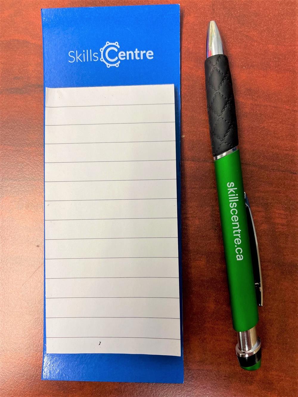 a pen next to a notepad