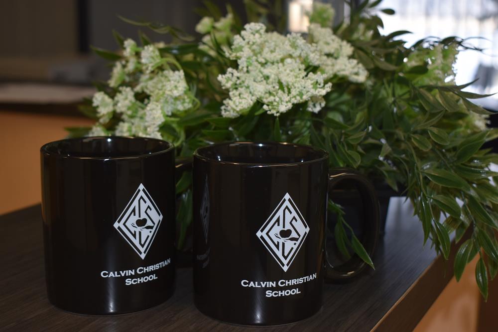 two black coffee mugs with white flowers