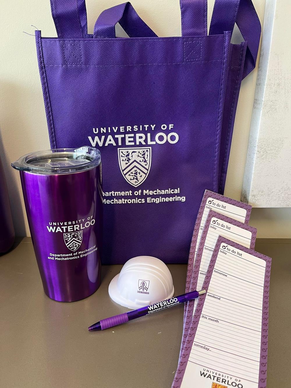 a purple bag with a pen and a cup
