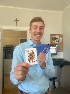 a man holding a card and a pair of cards