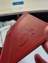 a red leather cover with a logo on it