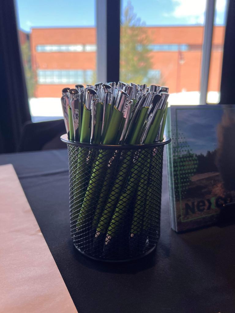 a group of pens in a holder