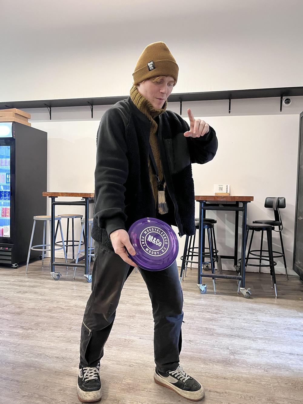 a man holding a purple frisbee