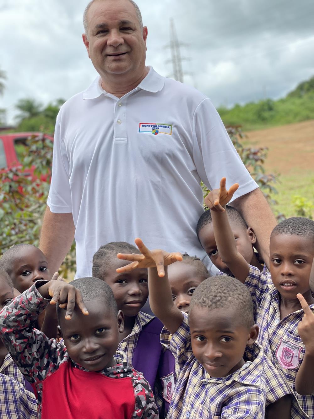 a man standing in front of a group of children