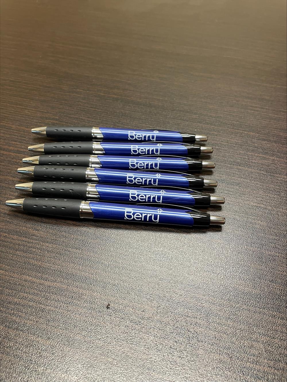 a group of pens on a table