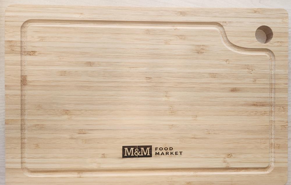 a wooden cutting board with a logo on it