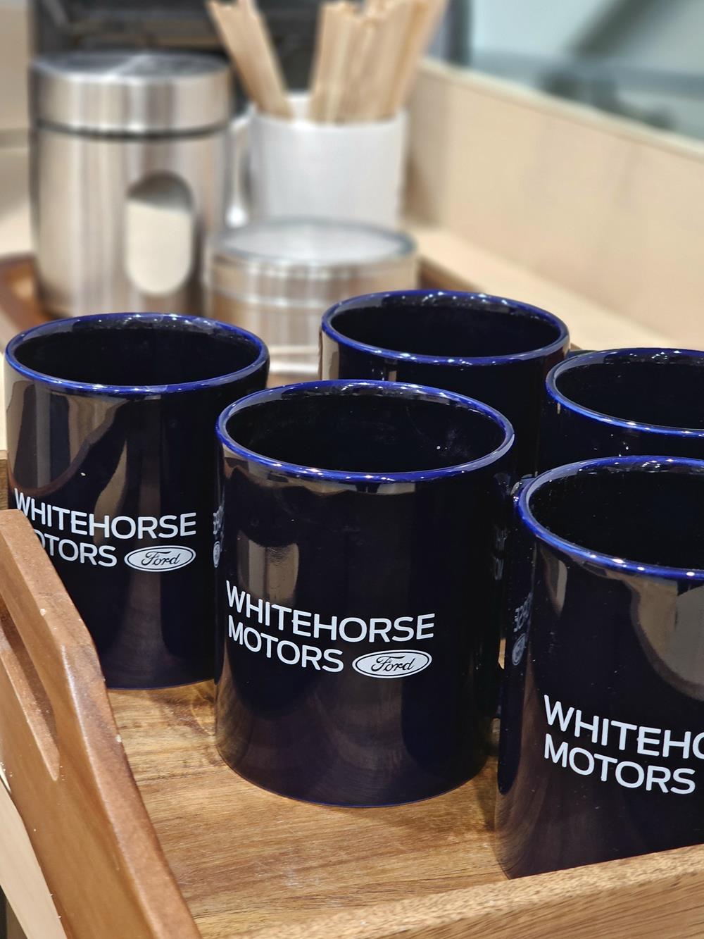 a group of blue mugs on a wooden tray